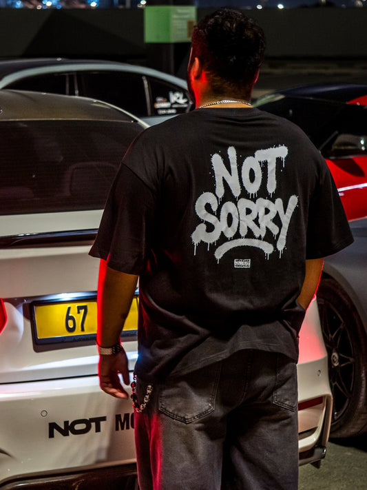 Black NOT SORRY tee worn