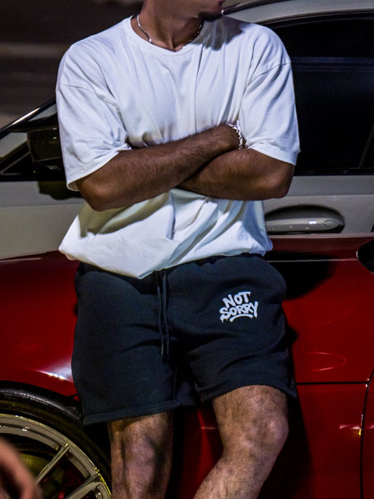 White NOT SORRY tee worn